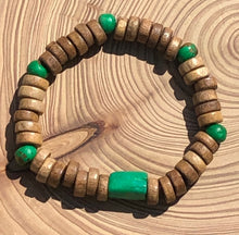 Load image into Gallery viewer, Handmade beaded bracelet on elastic. Made out of emerald green and brown recycled beads.