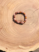 Load image into Gallery viewer, Handmade beaded bracelet on elastic. Made out dusty pink, brown and beige recycled beads.
