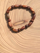 Load image into Gallery viewer, Handmade beaded bracelet on elastic. Made out of brown recycled beads.