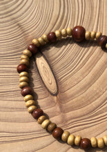 Load image into Gallery viewer, Handmade beaded bracelet on elastic. Made out of delicate small wooden recycled beads.