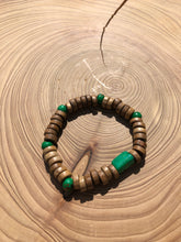 Load image into Gallery viewer, Handmade beaded bracelet on elastic. Made out of emerald green and brown recycled beads.
