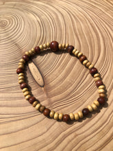 Load image into Gallery viewer, Handmade beaded bracelet on elastic. Made out of delicate small wooden recycled beads.