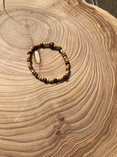 Load image into Gallery viewer, Handmade beaded bracelet on elastic. Made out of delicate small wooden recycled beads.