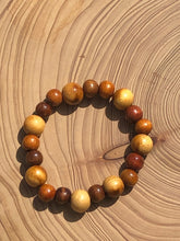 Load image into Gallery viewer, Handmade beaded bracelet on elastic. Made out of brown and beige recycled beads.