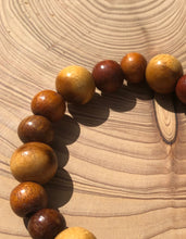 Load image into Gallery viewer, Handmade beaded bracelet on elastic. Made out of brown and beige recycled beads.