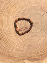Load image into Gallery viewer, Handmade beaded bracelet on elastic. Made out of brown recycled beads.