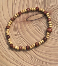 Load image into Gallery viewer, Handmade beaded bracelet on elastic. Made out of delicate small wooden recycled beads.