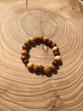 Load image into Gallery viewer, Handmade beaded bracelet on elastic. Made out of brown and beige recycled beads.