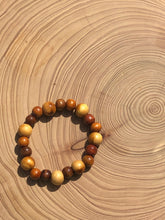 Load image into Gallery viewer, Handmade beaded bracelet on elastic. Made out of brown and beige recycled beads.