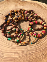 Load image into Gallery viewer, Handmade beaded bracelet on elastic. Made out of brown recycled beads.