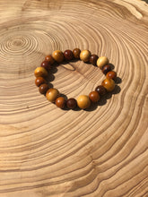 Load image into Gallery viewer, Handmade beaded bracelet on elastic. Made out of brown and beige recycled beads.