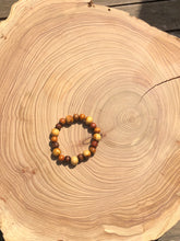 Load image into Gallery viewer, Handmade beaded bracelet on elastic. Made out of brown and beige recycled beads.