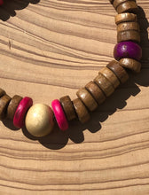 Load image into Gallery viewer, Handmade beaded bracelet on elastic. Made out hot pink, purple, brown and beige recycled beads.