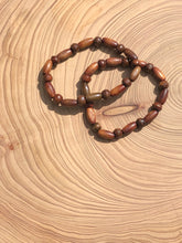 Load image into Gallery viewer, Handmade beaded bracelet on elastic. Made out of brown recycled beads.