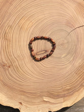 Load image into Gallery viewer, Handmade beaded bracelet on elastic. Made out of brown recycled beads.
