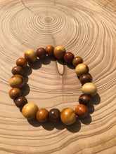 Load image into Gallery viewer, Handmade beaded bracelet on elastic. Made out of brown and beige recycled beads.