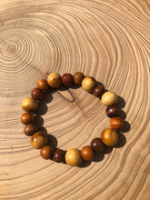 Load image into Gallery viewer, Handmade beaded bracelet on elastic. Made out of brown and beige recycled beads.