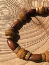 Load image into Gallery viewer, Handmade beaded bracelet on elastic. Made out of brown and beige textured recycled beads.