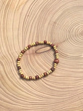 Load image into Gallery viewer, Handmade beaded bracelet on elastic. Made out of delicate small wooden recycled beads.