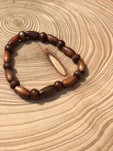 Load image into Gallery viewer, Handmade beaded bracelet on elastic. Made out of brown recycled beads.
