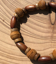 Load image into Gallery viewer, Handmade beaded bracelet on elastic. Made out of brown and beige textured recycled beads.