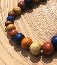 Load image into Gallery viewer, handmade beaded bracelet on elastic. Made out blue, brown and beige recycled beads.